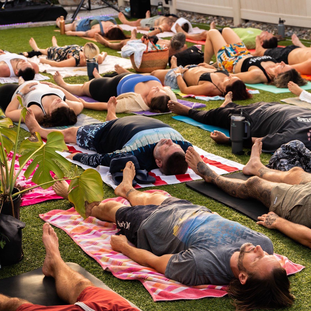 Group breathwork session on the outdoor lawn at Plunsana studio